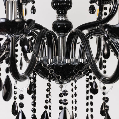 Closeup of chandelier with black finish and crystal detailing showing elegant luxury lighting fixture design.