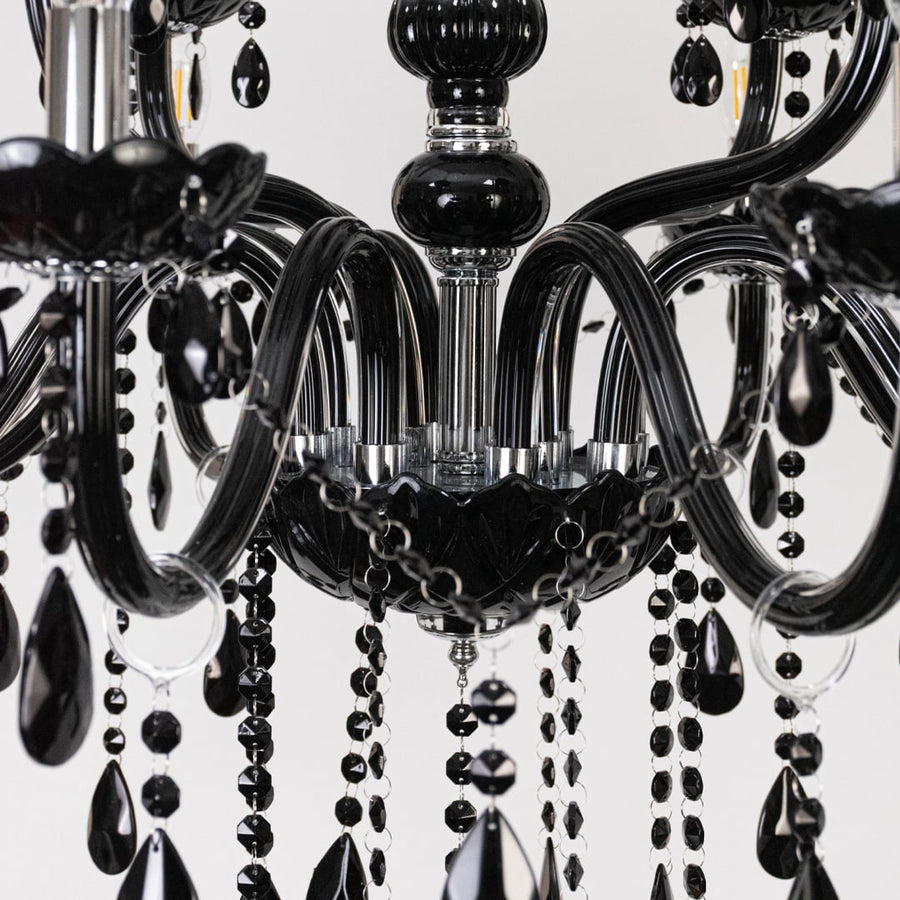 Closeup of chandelier with black finish and crystal detailing showing elegant luxury lighting fixture design.