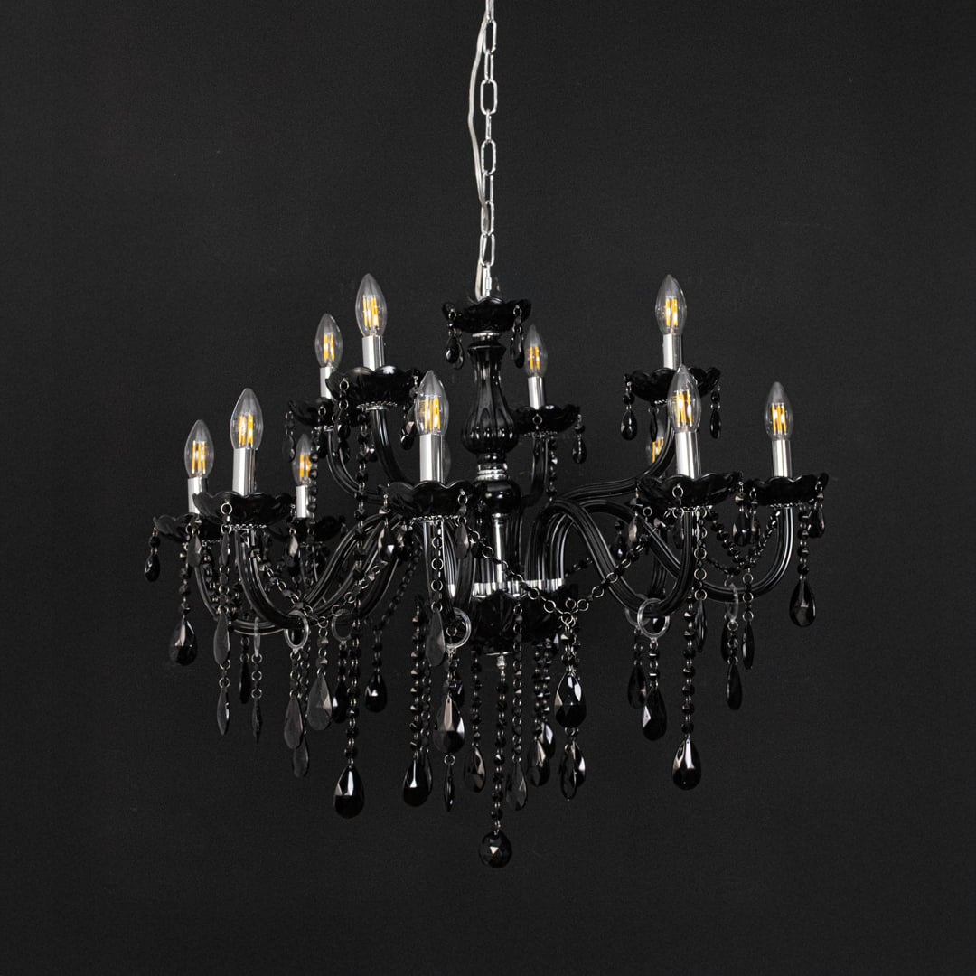 Chandelier with black frame and crystal droplets displayed off against black background for modern luxury style.