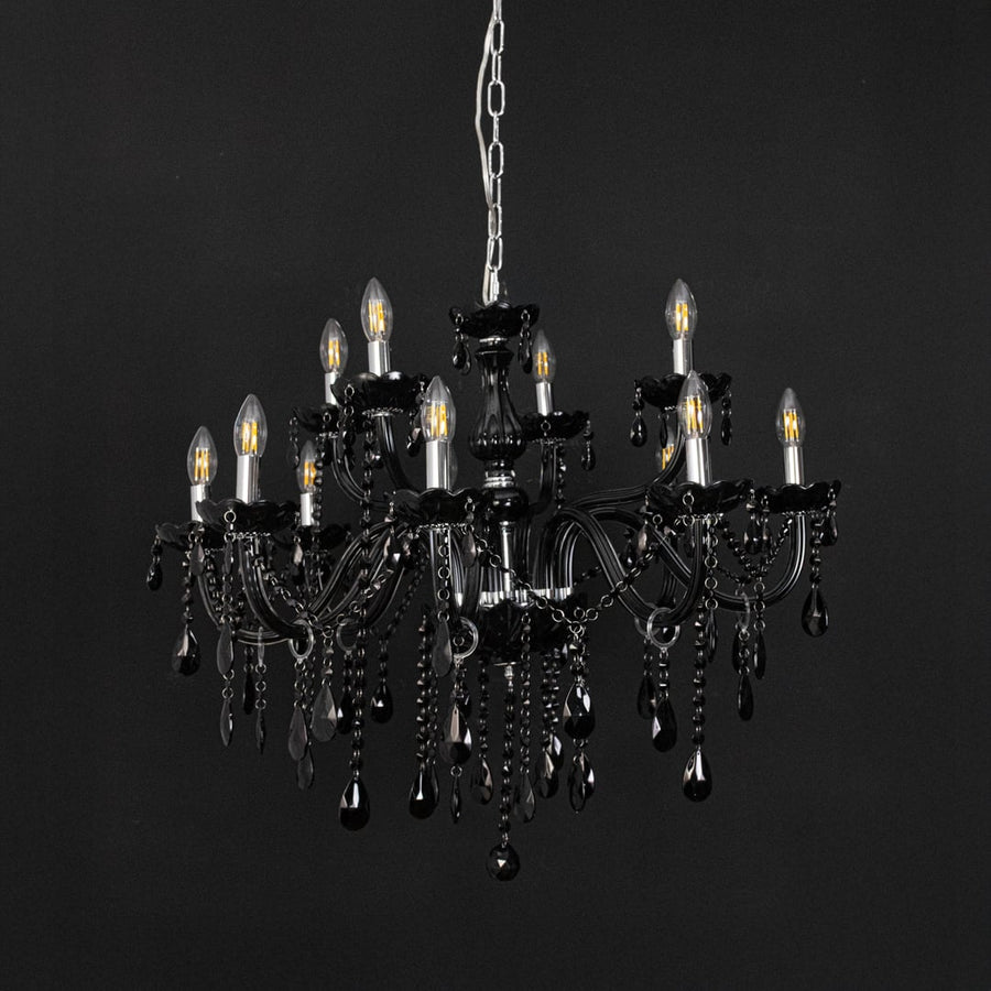 Chandelier with black frame and crystal droplets displayed off against black background for modern luxury style.