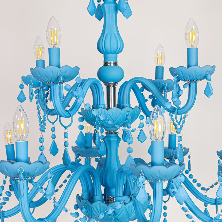 Closeup of large blue crystal chandelier with detailed beads and curved arms perfect for bold luxury ceiling decor.