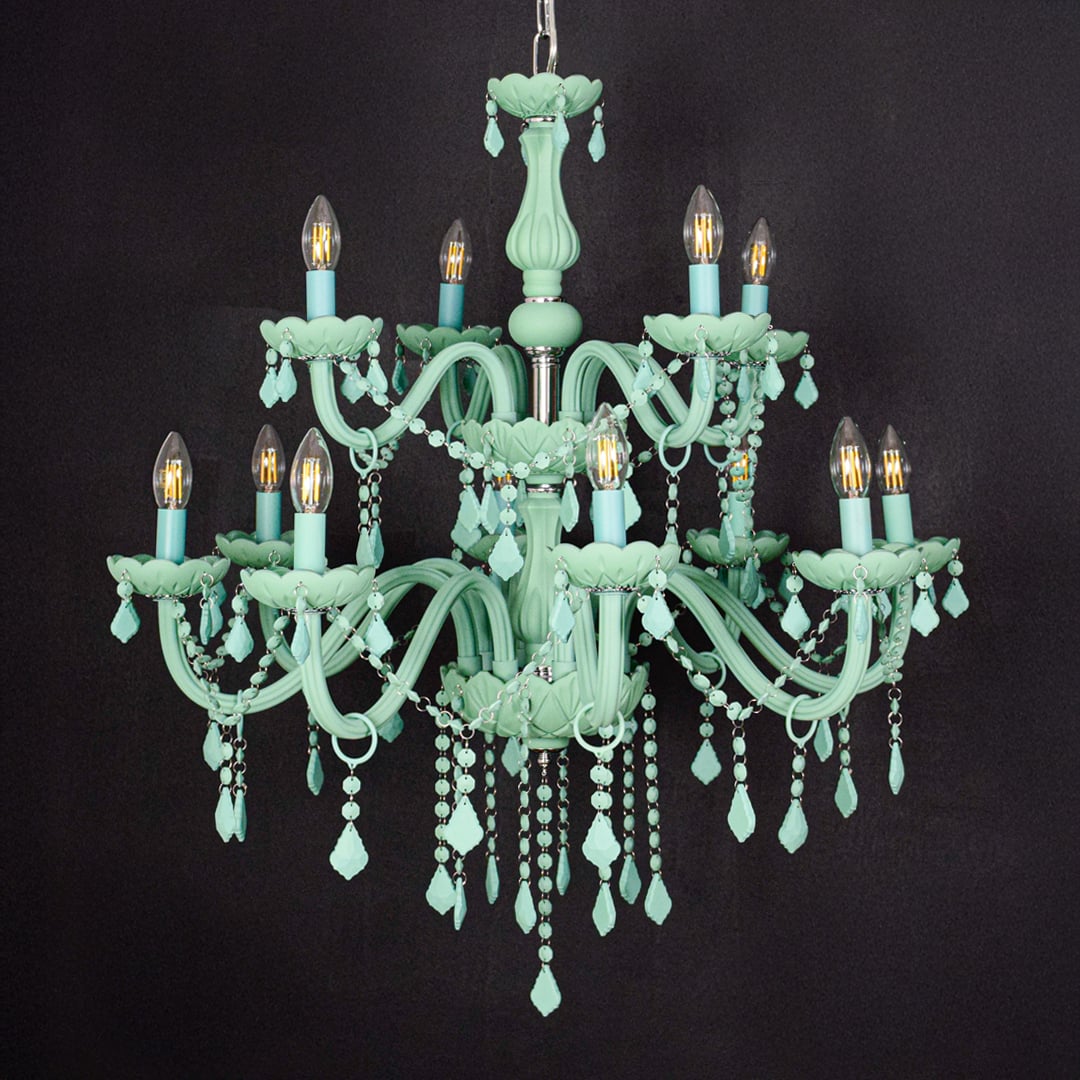 Large green crystal chandelier shown on black background highlighting bold vibrant details for elegant interior ceilings.