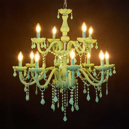 Large green crystal chandelier glowing warmly on black background creating a striking modern luxury ceiling feature.