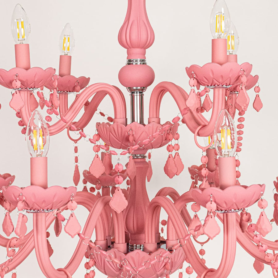 Closeup of large pink crystal chandelier with detailed beads and curved arms perfect for stylish luxury ceiling decor.