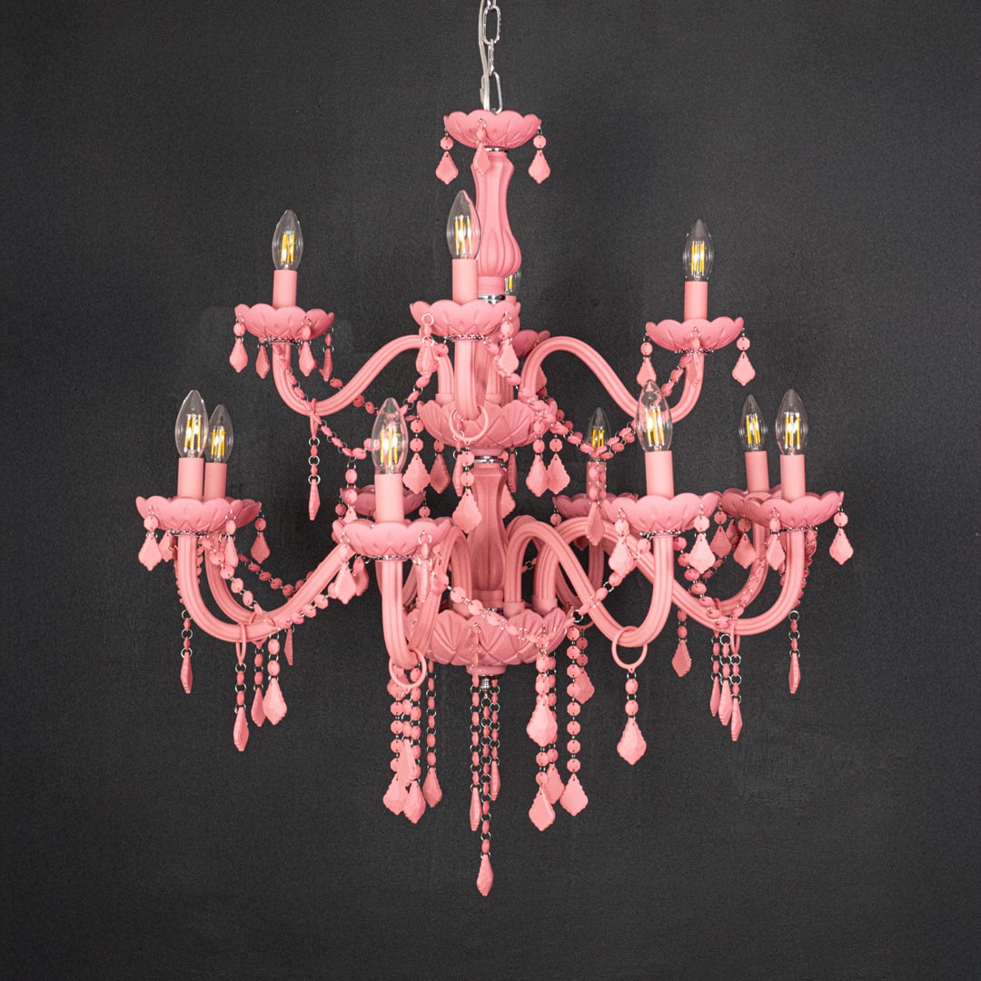 Large pink crystal chandelier shown on black background highlighting bold vibrant detailing for elegant ceiling design.