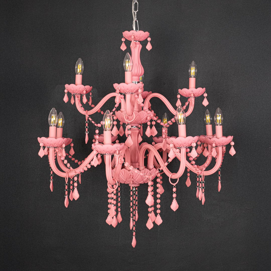 Large pink crystal chandelier shown on black background highlighting bold vibrant detailing for elegant ceiling design.