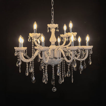 Elegant white chandelier with crystal accents illuminated against black background for luxury interior lighting.