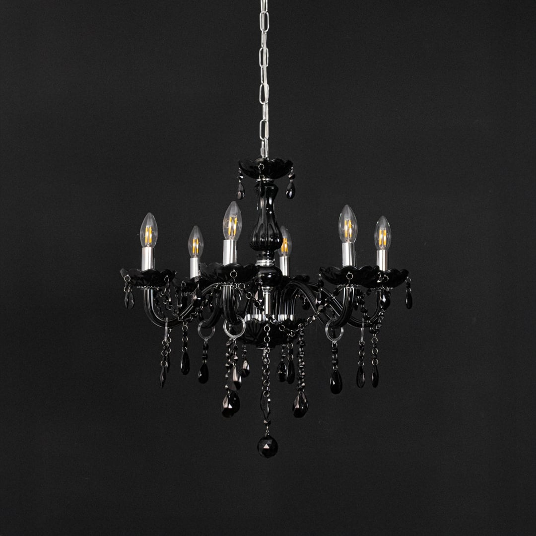 Black chandelier with crystal glass and glossy frame displayed off against black background for modern decor.