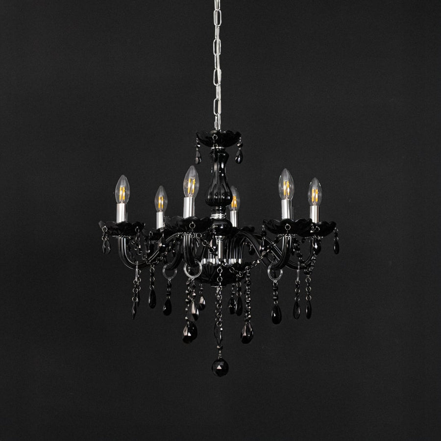 Black chandelier with crystal glass and glossy frame displayed off against black background for modern decor.