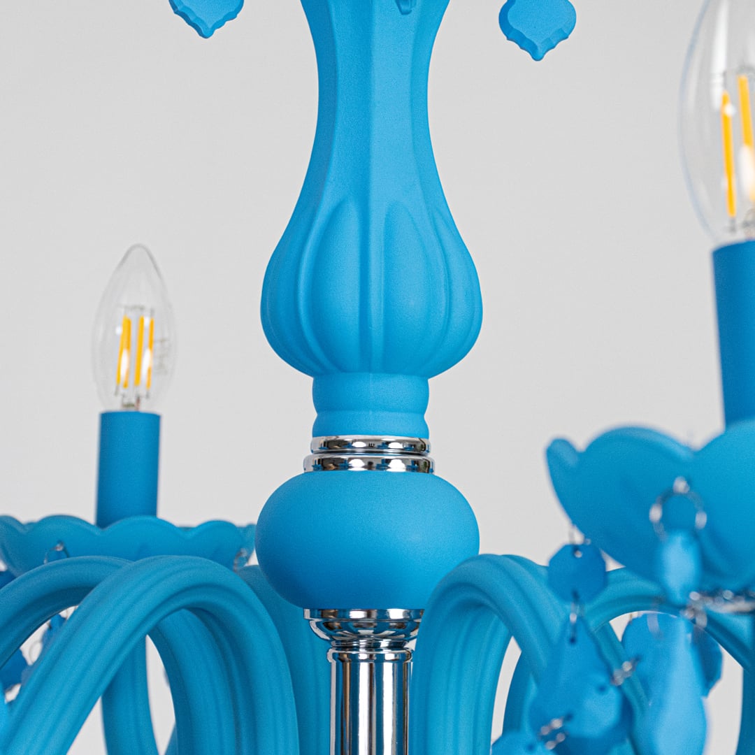 Closeup of blue crystal chandelier with detailed crystal beads and curved arms perfect for modern luxury ceiling lighting.