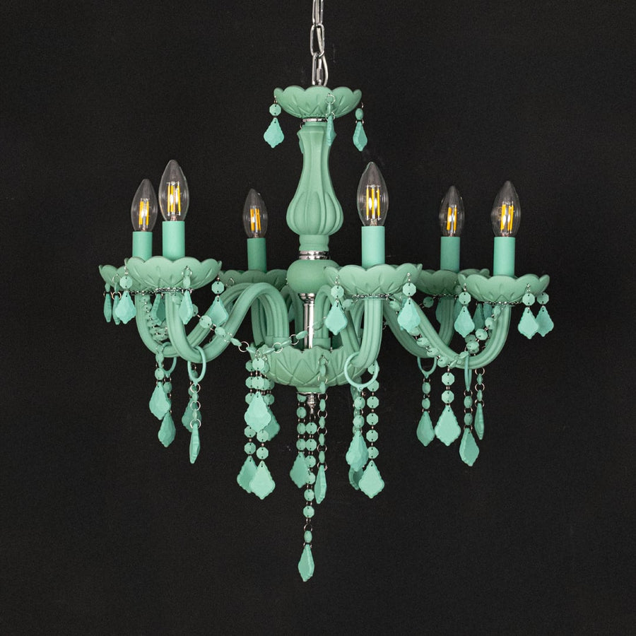 Green crystal chandelier shown on black background highlighting bold vibrant details for elegant interior decor.
