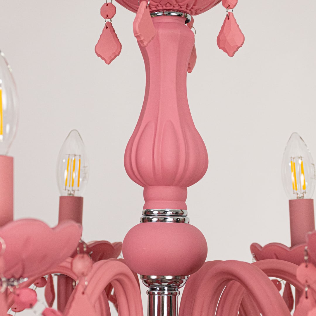 Closeup of pink crystal chandelier with detailed beads and curved arms perfect for stylish luxury ceiling lighting.