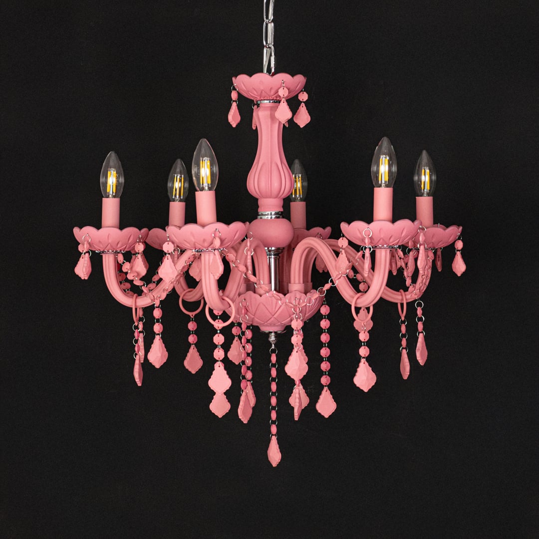 Pink crystal chandelier shown on black background highlighting bold vibrant details for elegant interior decor.