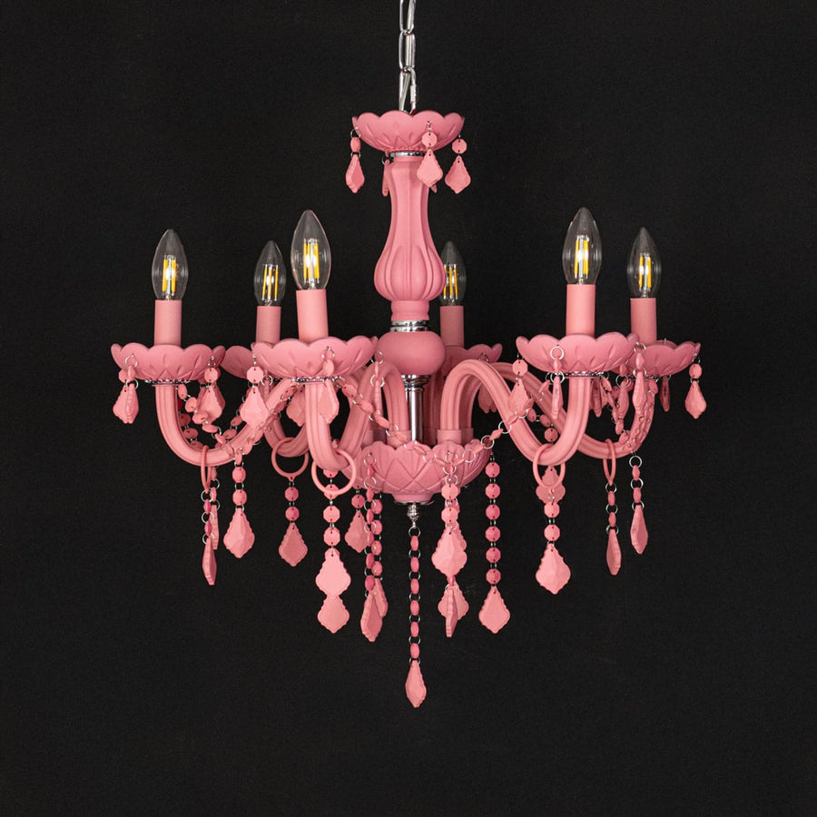 Pink crystal chandelier shown on black background highlighting bold vibrant details for elegant interior decor.