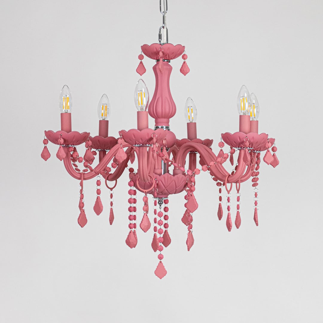 Pink crystal chandelier displayed on white background ideal for colorful bright interior ceiling styling.