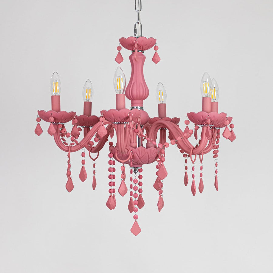 Pink crystal chandelier displayed on white background ideal for colorful bright interior ceiling styling.
