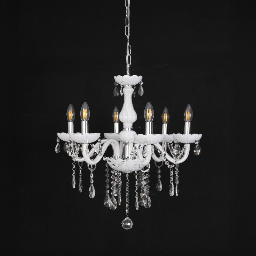 White chandelier with crystal details displayed off against black background highlighting modern interior style.