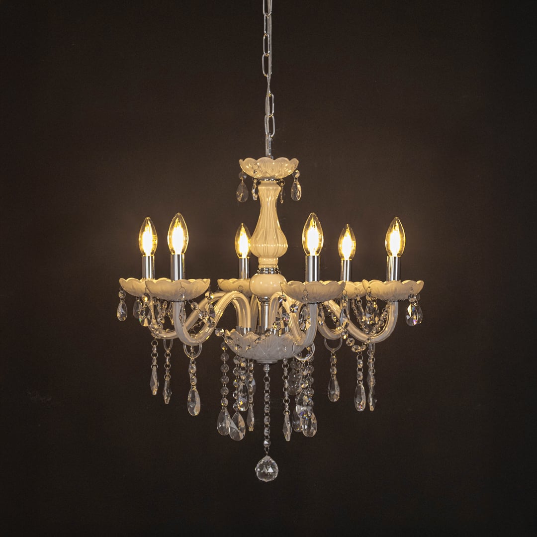 Elegant white chandelier with crystal details illuminated against black background for luxury home lighting.