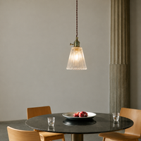 Lifestyle image of bimbo glass hanging light for elegant modern dining room decor styling and luxury interior lighting.