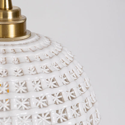 Closeup of white woven pendant light showing detailed lattice pattern and elegant gold mounting.