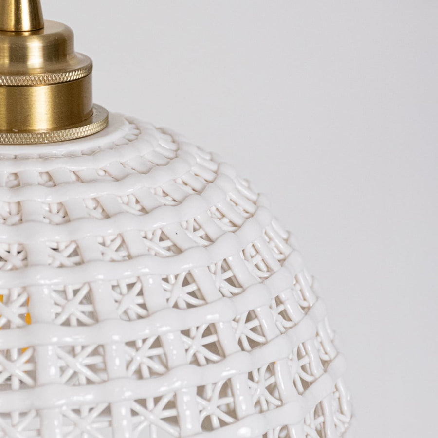 Closeup of white woven pendant light showing detailed lattice pattern and elegant gold mounting.