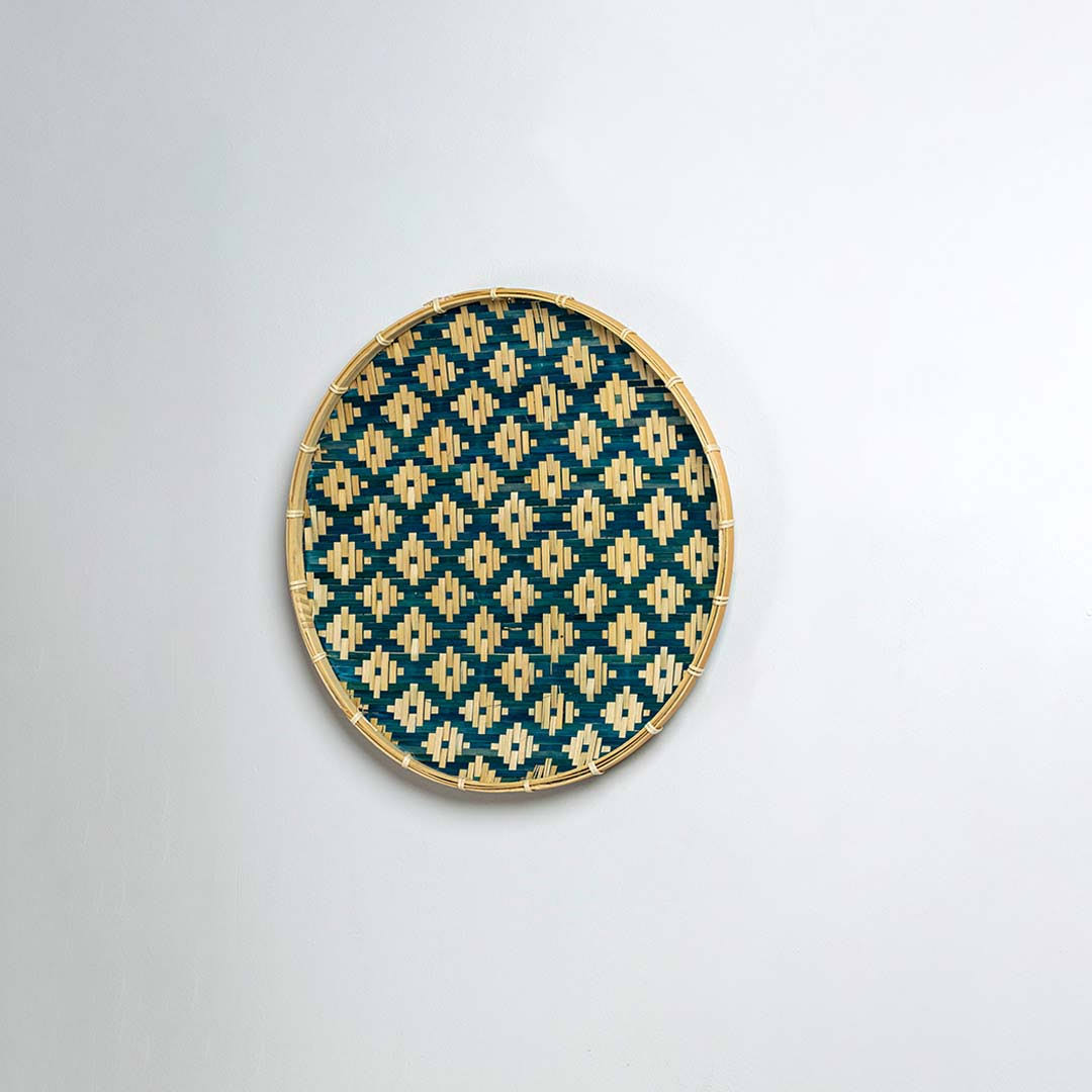 Natural woven blue and beige seagrass wall basket for living room boho décor on white background image.