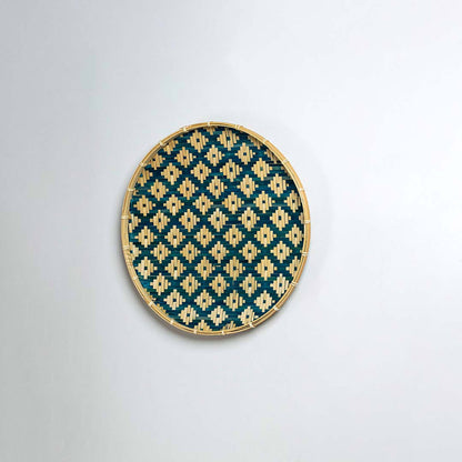 Natural woven blue and beige seagrass wall basket for living room boho décor on white background image.