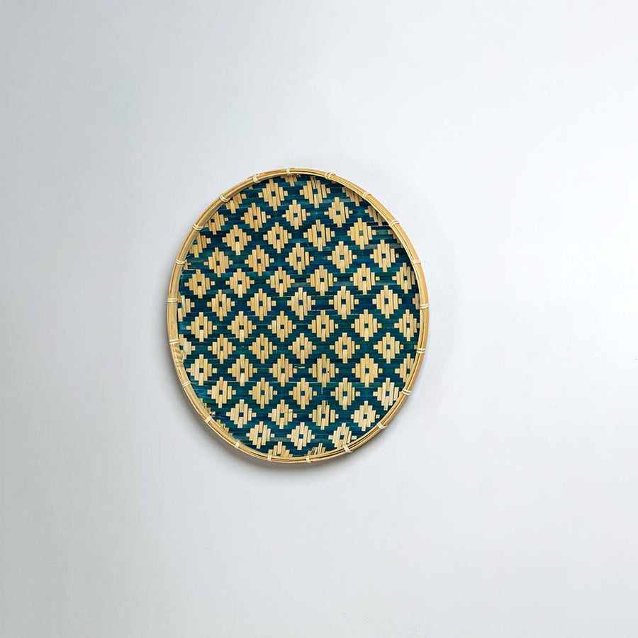 Natural woven blue and beige seagrass wall basket for living room boho décor on white background image.