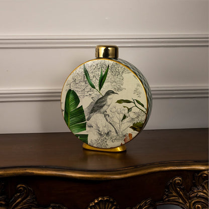 Tropical bird jar showcasing intricate tropical prints and gold detailing on neutral backdrop.