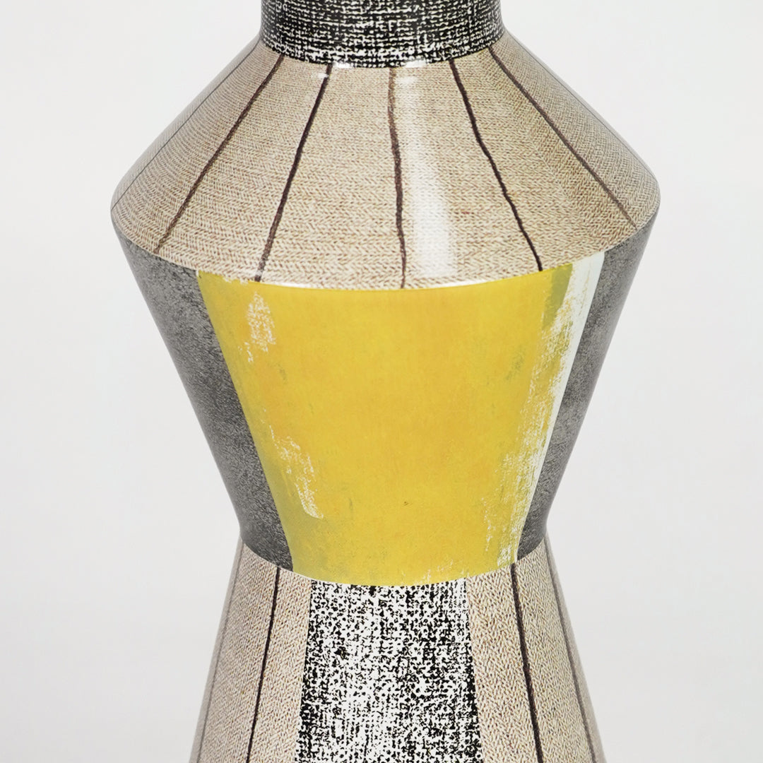 Closeup image of yellow glass table lamp with metallic detailing for luxury bedside decor styling and elegance.