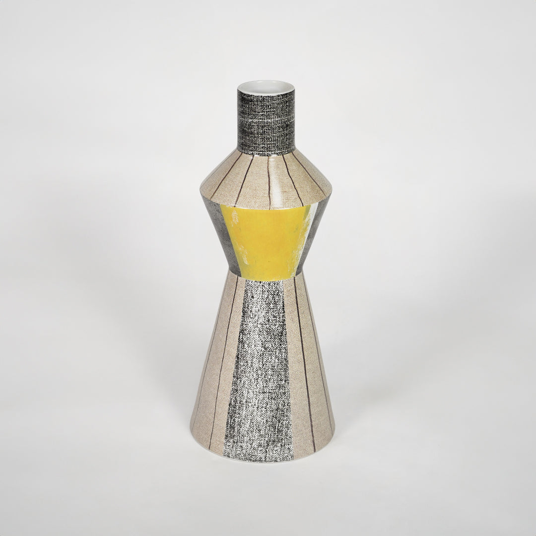 Modern silver decorative vase with yellow glass detail for stylish shelf placement and contemporary home decor styling.