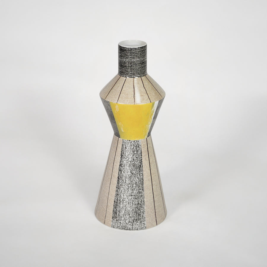 Modern silver decorative vase with yellow glass detail for stylish shelf placement and contemporary home decor styling.
