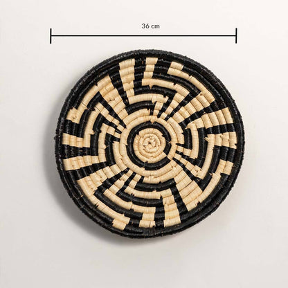 Dimension image of handcrafted black cream seagrass wall basket with geometric sunburst labyrinth pattern for boho decor.