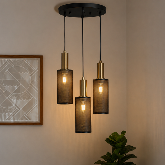 Industrial black metal 3-light cluster pendant fixture with mesh cylinder shades and brass accents hanging in a living room corner.