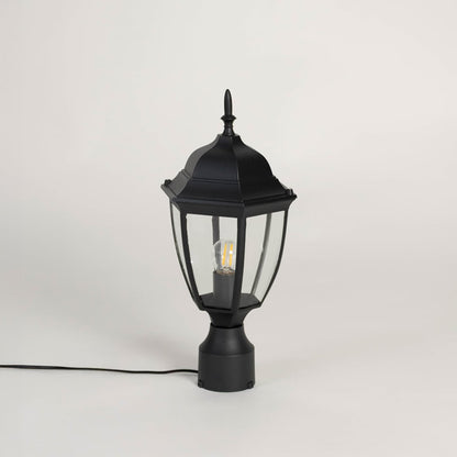 Stylish black outdoor pillar lamp with transparent glass panels designed for modern patio garden and balcony lighting.