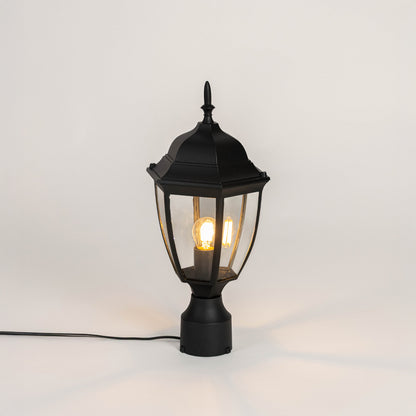 Modern black outdoor gate light with glowing bulb and metal frame for stylish exterior decor use.