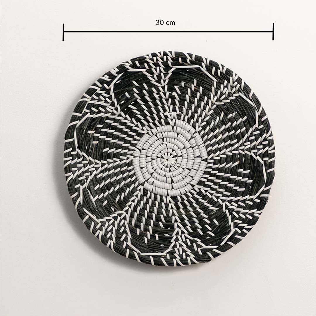 Dimension image of handcrafted black and white seagrass wall basket with woven floral petal pattern for boho wall decor.