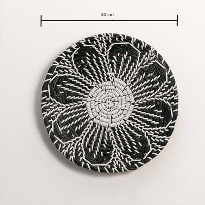 Dimension image of handcrafted black and white seagrass wall basket with woven floral petal pattern for boho wall decor.