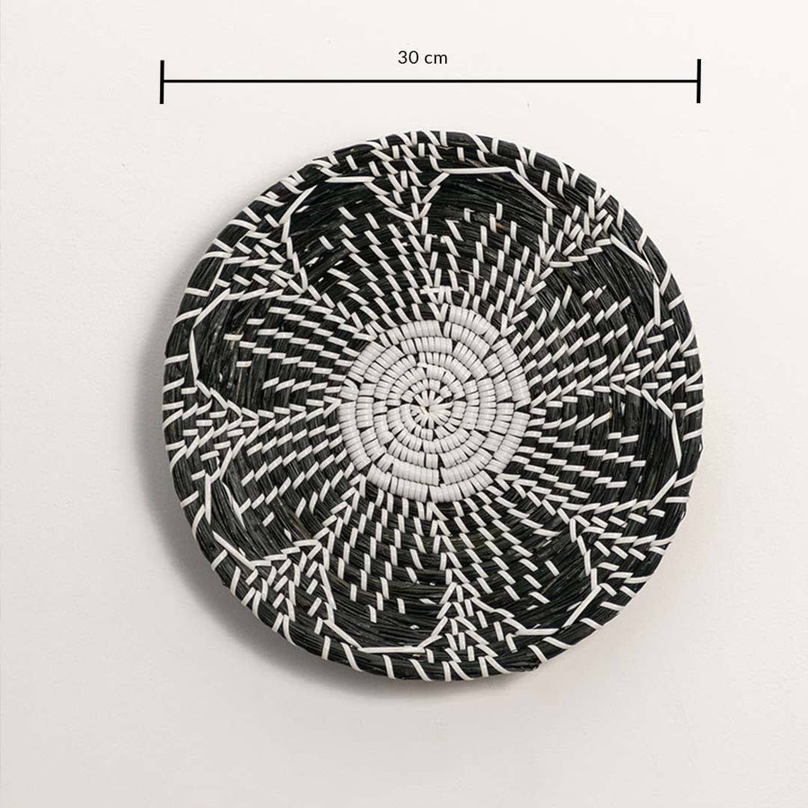 Dimension image of handcrafted black and white seagrass wall basket with woven floral petal pattern for boho wall decor.
