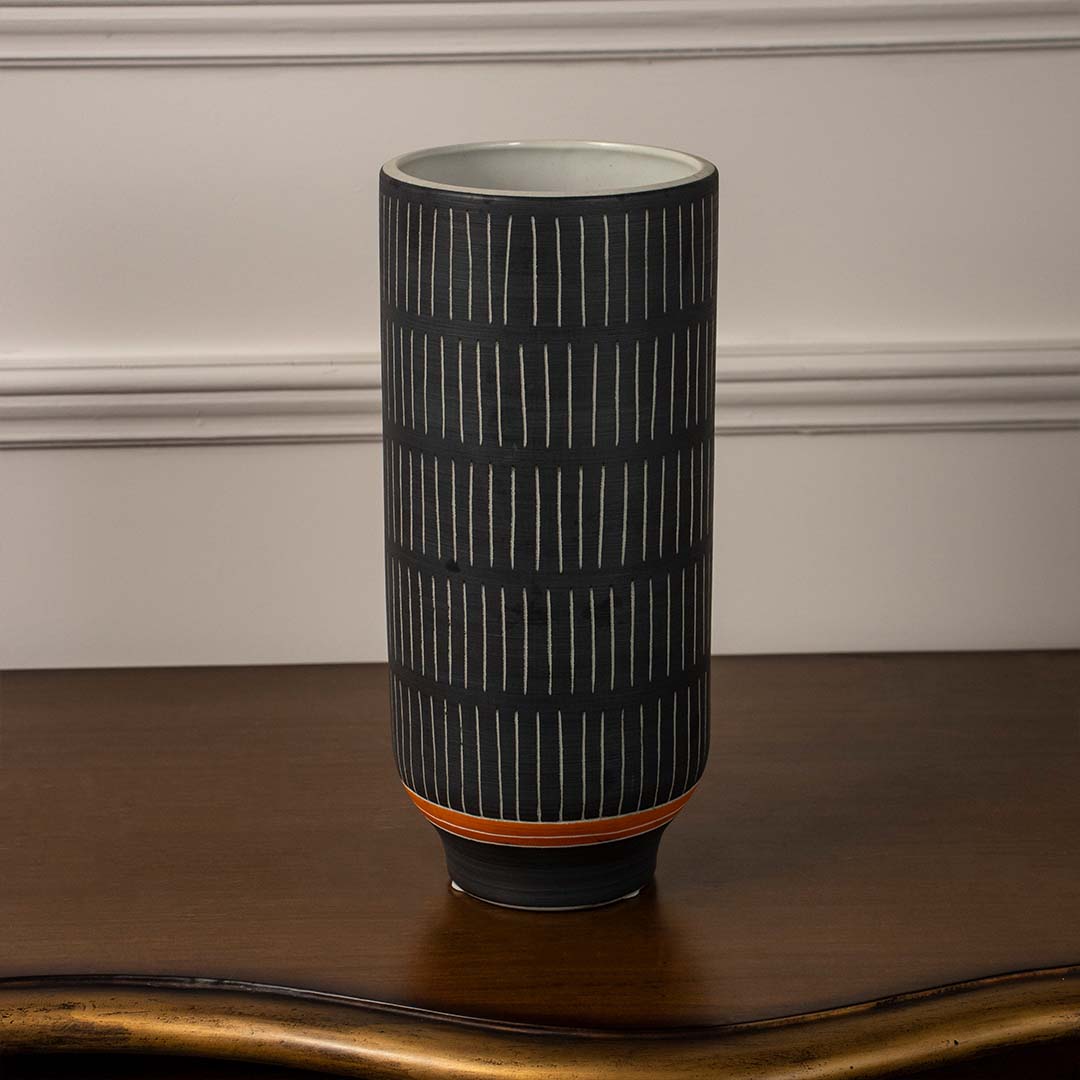 Black ribbed ceramic decorative vase displayed on white background offering modern minimalist accent for shelf or console decor.