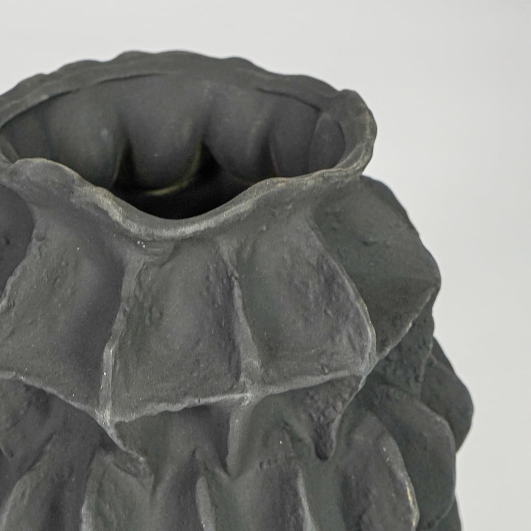 black textured round ceramic vase closeup