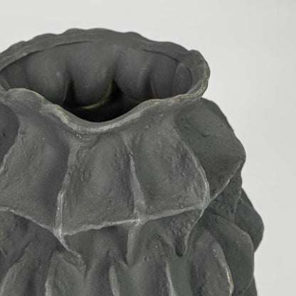 black textured round ceramic vase closeup