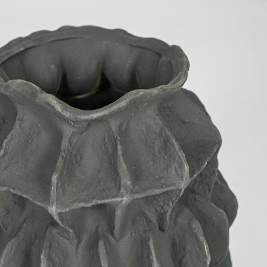 black textured round ceramic vase closeup