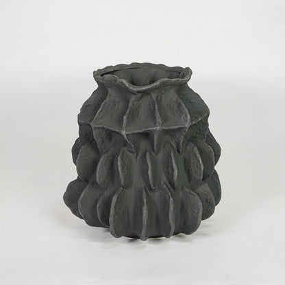 black textured round ceramic vase white background