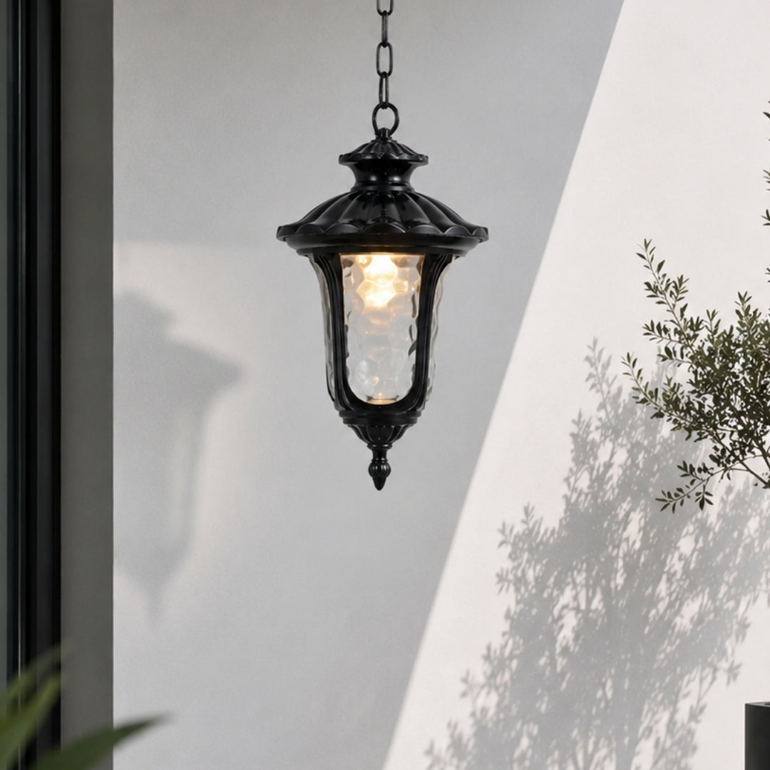 Black metal outdoor hanging lantern for porch entrance patio and covered balcony with warm ambient lighting.