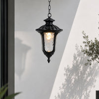 Black metal outdoor hanging lantern for porch entrance patio and covered balcony with warm ambient lighting.