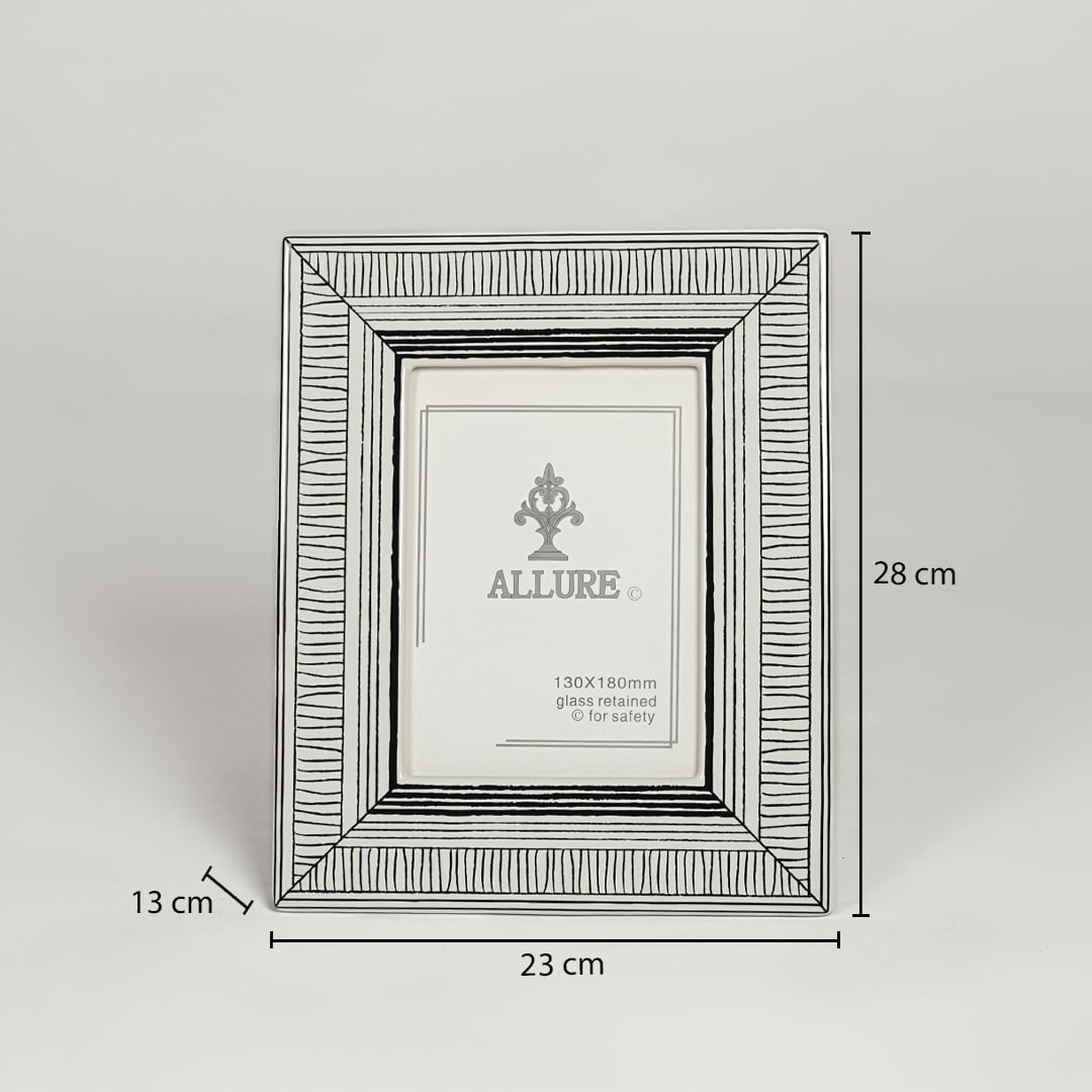 Silver metal photo frame measuring 28 cm height 23 cm width and 13 cm depth perfect for tabletop display decor.