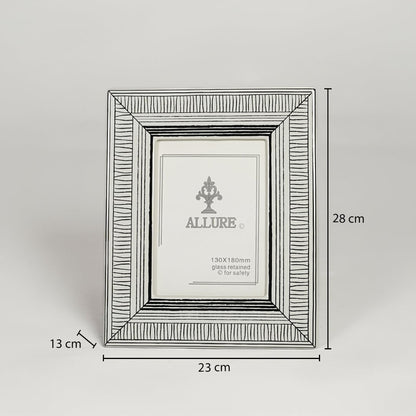 Silver metal photo frame measuring 28 cm height 23 cm width and 13 cm depth perfect for tabletop display decor.