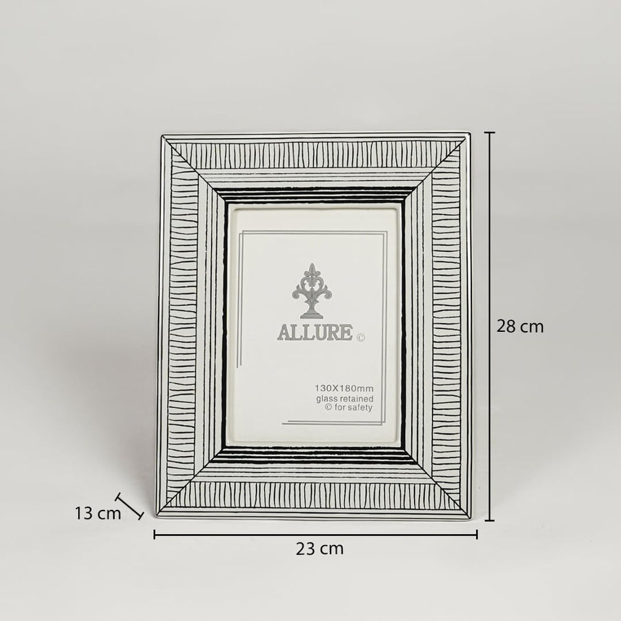 Silver metal photo frame measuring 28 cm height 23 cm width and 13 cm depth perfect for tabletop display decor.