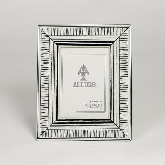 Silver metal photo frame with detailed patterned border isolated on clean white background for elegant tabletop display.